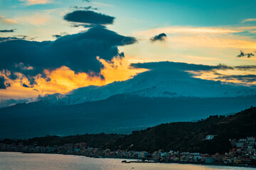 Sunset  over the mountains. Orange glow behind Mount Etna 