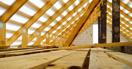 roof construction - a wooden roof frame covered with a waterproofing film, fixing rafters, beams, racks © Елена 