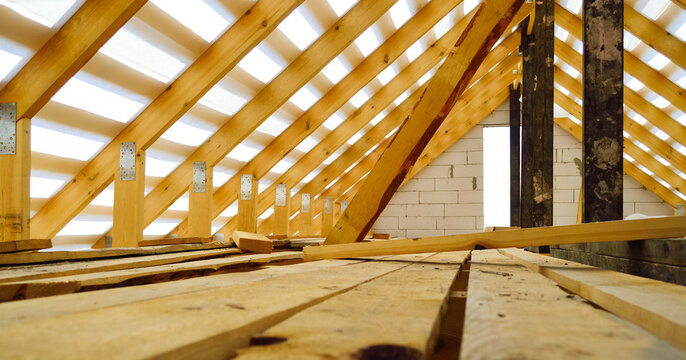 roof construction - a wooden roof frame covered with a waterproofing film, fixing rafters, beams, racks