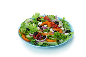 Plate of greek salad isolated on white background