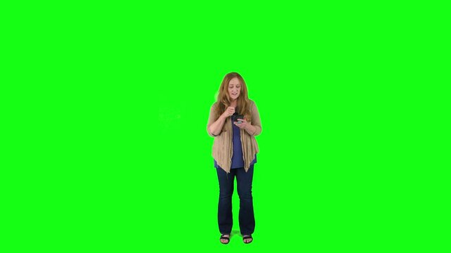 Shopper types in information using credit card and smartphone in front of green screen