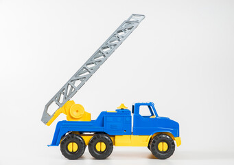 Plastic car. Toy model isolated on a white background. Yellow-blue truck with fire escape.