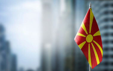 A small flag of Macedonia on the background of a blurred background