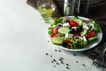 Concept of delicious food with Greek salad on white textured background