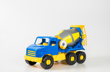 Plastic car. Toy model isolated on a white background. Yellow-blue concrete truck.