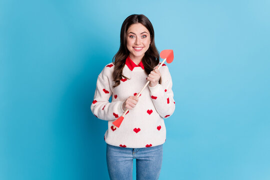 Photo of charming funny young woman dressed hearts print pullover holding heart arrows isolated blue color background