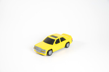 Toy plastic car isolated on white background. Yellow car.