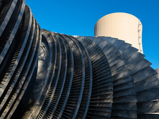 Steam turbine against nuclear power plant and sky