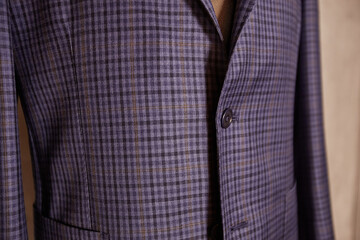 Men's casual checkered tweed grey coat and blue shirt lapel with tie closeup