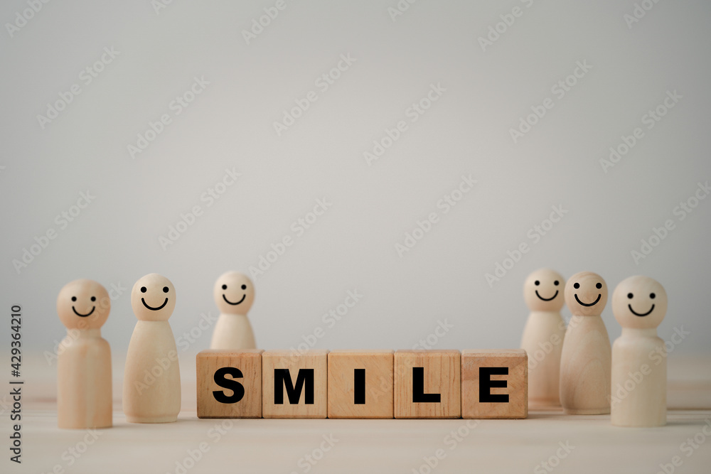 Poster smiley face on wooden miniature figure with smile wording on wooden cube for the best customer evalu