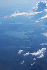 Aerial view of blue sky and white clouds over 
Yucatan peninsula, Mexico. View from airplane. Soft focus