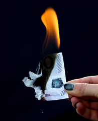 Five hundred Euros burn from a match isolated on a black