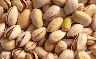 Close-up of fresh pistachio nuts as background.