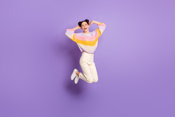 Full length photo of charming cute young woman wear striped pullover jumping arms head isolated purple color background