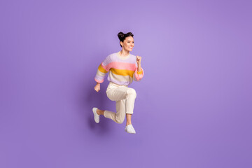 Fototapeta na wymiar Full length photo of pretty sweet young lady dressed striped sweater jumping running isolated violet color background