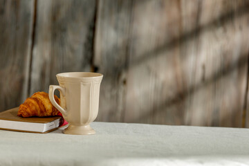 Old wooden kitchen with sun rays and a table for dishes 
