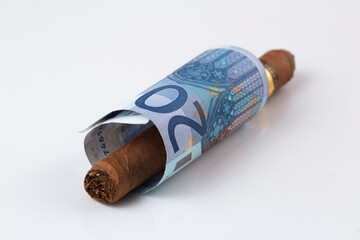 Rolled Cash and Cuban cigar stock photo