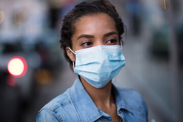 Woman on street wearing protective face mask.