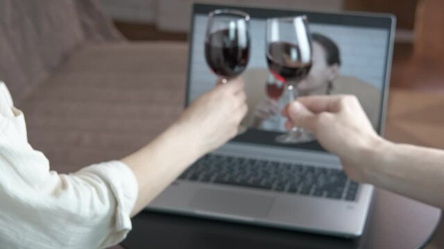 Remote friends meeting online. Friends on self isolation celebrate on remote a day with red wine.