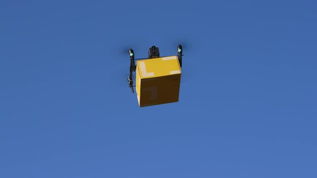 delivery drone carrying parcel flying across the blue sky