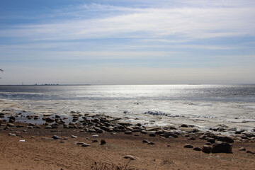 View of the bay and the ice floes near the shore on a sunny spring day 