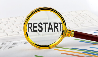 Magnifying glass with the word RESTART on the chart background
