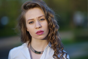 Naklejka premium Portrait of a young beautiful girl in the park