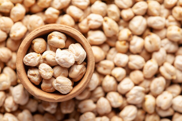 Macro Close-up of Organic chhole chana or Kabuli chana (Cicer arietinum) or whole white Bengal gram dal in an earthen clay pot (kulhar) on the self background. Top view