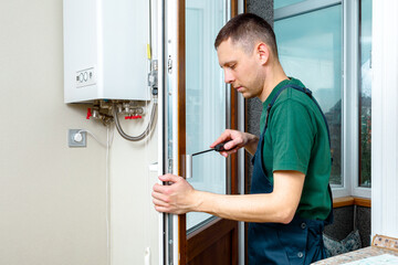The worker installing and checking window in the house