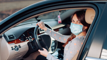 Woman in the medical mask in car. coronavirus, disease, infection, quarantine, covid-19