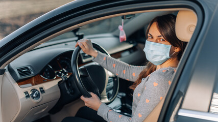 Woman in the medical mask in car. coronavirus, disease, infection, quarantine, covid-19