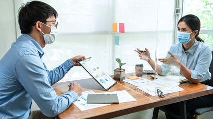 Asian business man showing financial chart to colleagues and discussion about new project