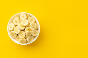 Banana slices in bowl. Fresh friuts top view