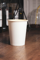 A coffee cup with no labels on the bar. Place for the text, copy space.