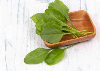 Close up of fresh green spinach isolated on wooden background