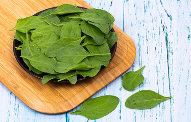 Close up of fresh green spinach isolated on wooden background