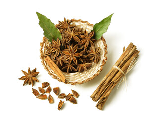 cinnamon sticks and star anise in a basket with laurel leaves on a white background.Scented spices