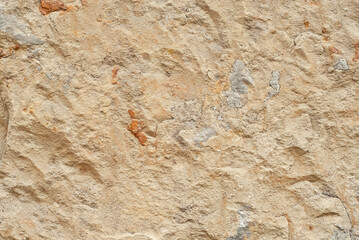 Plaster on a yellow wall. Concrete wall texture close up.
