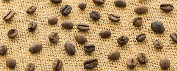 Beans of coffee  on the  burlap woven. Coffee beans  on burlap woven in full screen.