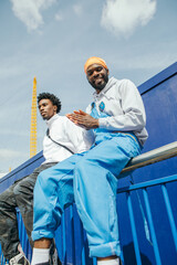 Two friends sitting on railing