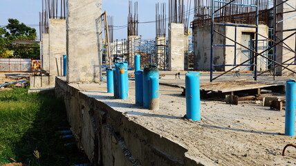 Blue PVC pipes on the building floor. Installation of PVC pipes under concrete floors for sewer systems and toilets of buildings under construction on the background of curing cement columns.