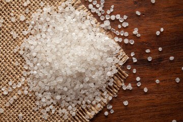 Macro Close-up of Organic white Sago or Sabudana (Metroxylon sagu) on Jute mat and wooden top.