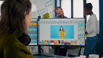 Fototapeta na wymiar Freelancer retoucher woman working at computer with photo editing sofware using stylus pen while retouching client photo. Photographer designer processing digital image in post production app