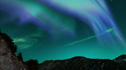 Aurora Borealis Green and Purple Loop Winter Mountain Ridges Northern Lights