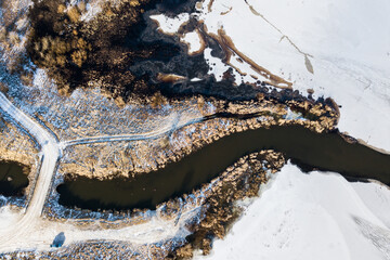 Aerial view of lake and canal in winter, Latvia.