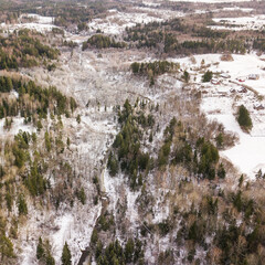 Fototapeta na wymiar Aerial view of winding river and forest in Riezupe river nature park in winter day, Latvia. 