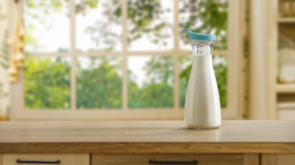 Fresh cold milk in bottle and window in home interior 