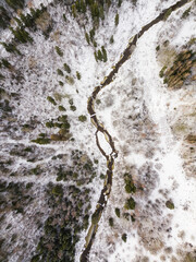 Aerial view of winding river, bridge, island and forest in Riezupe river nature park in winter day,...