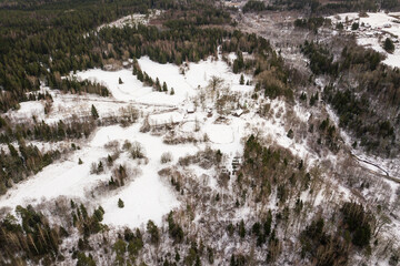 Fototapeta na wymiar Aerial view of country house and Riezupe river nature park in winter day, Latvia. 