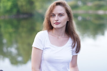 Portrait of a young beautiful girl in the park